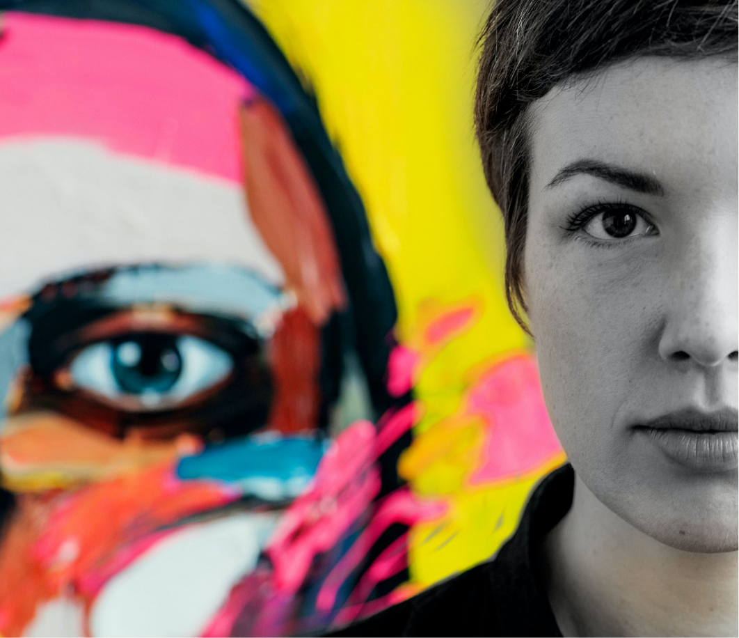 Close-up of half of a woman’s face with a colorful painted background