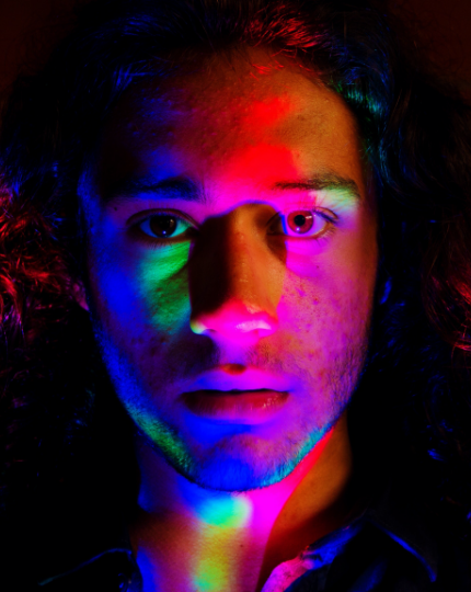 A man with colorful light over his face